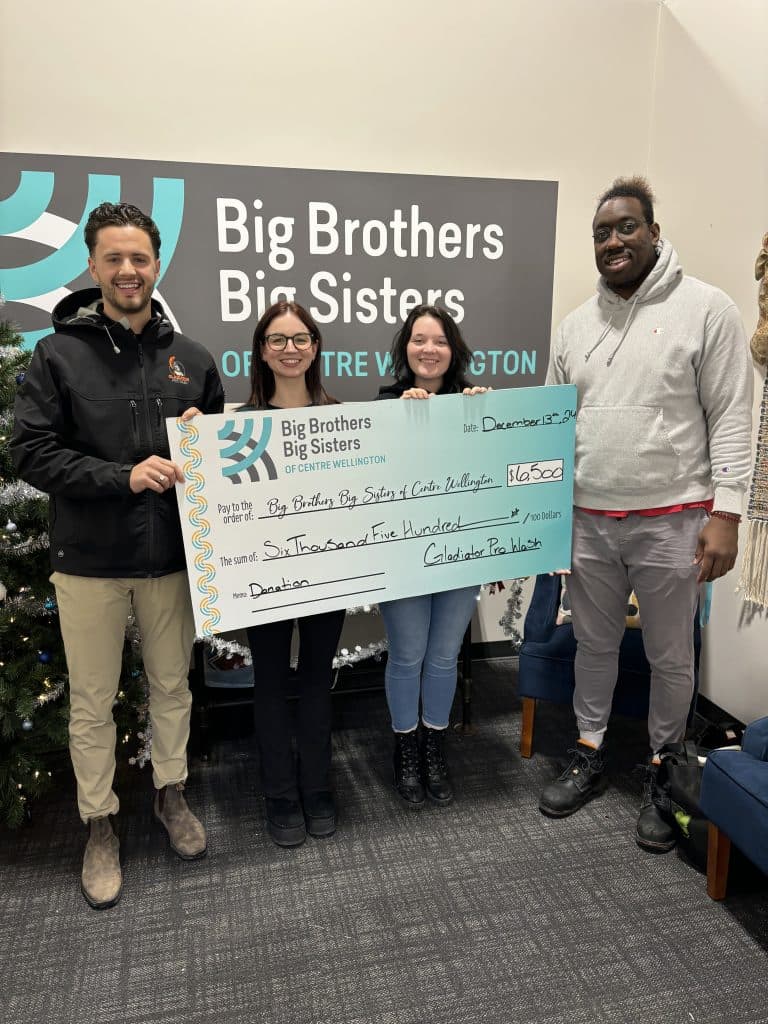 The Gladiator team presenting a $6,500 donation cheque at Big Brothers Big Sisters of Centre Wellington